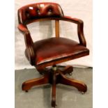 20th century ox-blood leather and mahogany captains chair. Upholstery in good condition, some