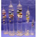 Five oil filled rise and fall thermometers, largest H: 33 cm. Not available for in-house P&P,