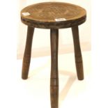 Ben Setter of Totnes; a carved oak milking stool with three turned supports, the seat carved with