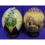 Two decorated ostrich eggs, Each raised on stand. P&P Group 2 (£18+VAT for the first lot and £3+