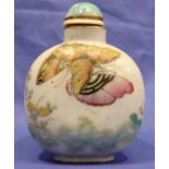 An 18th-19th century Chinese snuff bottle of rounded form, decorated with butterflies and flora,