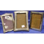 Three hallmarked silver desk photograph frames, various assay marks and sizes. P&P Group 3 (£25+