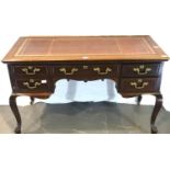 20th century mahogany writing desk with five drawers and red leather inset top. Not available for