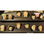 Twelve small character jugs on a wooden shelf, shelf H: 35 cm. P&P Group 3 (£25+VAT for the first