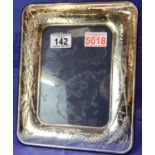 Hallmarked silver photograph frame with relief decoration, inner frame measures 17 x 12 cm. P&P