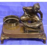 Japanese bronze figure preparing a fish on a low table, raised on a footed plinth and signed with