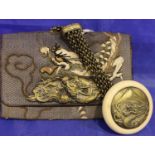 Japanese embroidered tobacco pouch decorated with a dragon, surmounted with a relief brass dragon
