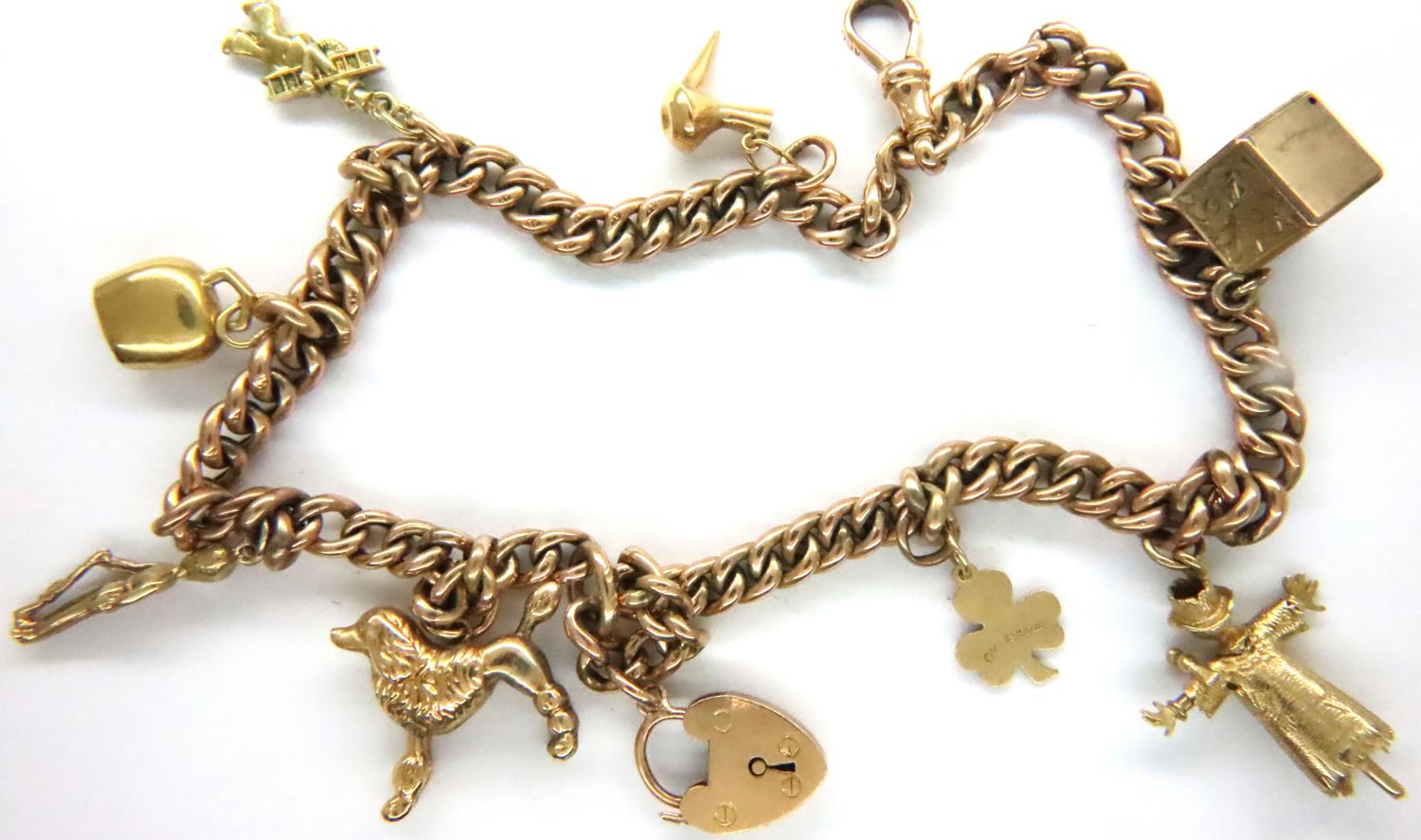 9ct gold bracelet with eight yellow metal charms, L: 32 cm, combined 30.1g. Some charms not