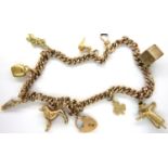 9ct gold bracelet with eight yellow metal charms, L: 32 cm, combined 30.1g. Some charms not