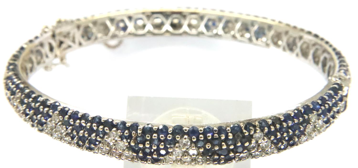 18ct white gold sapphire and diamond set snap bangle with guard chain, 65 x 60 mm, 23.8g. P&P