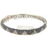 18ct white gold sapphire and diamond set snap bangle with guard chain, 65 x 60 mm, 23.8g. P&P