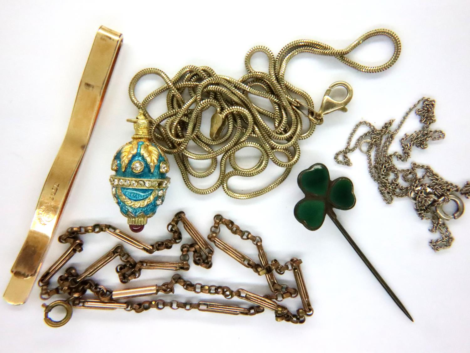 Collection of vintage costume jewellery, including an enamelled egg pendant, tie clip, neck chains