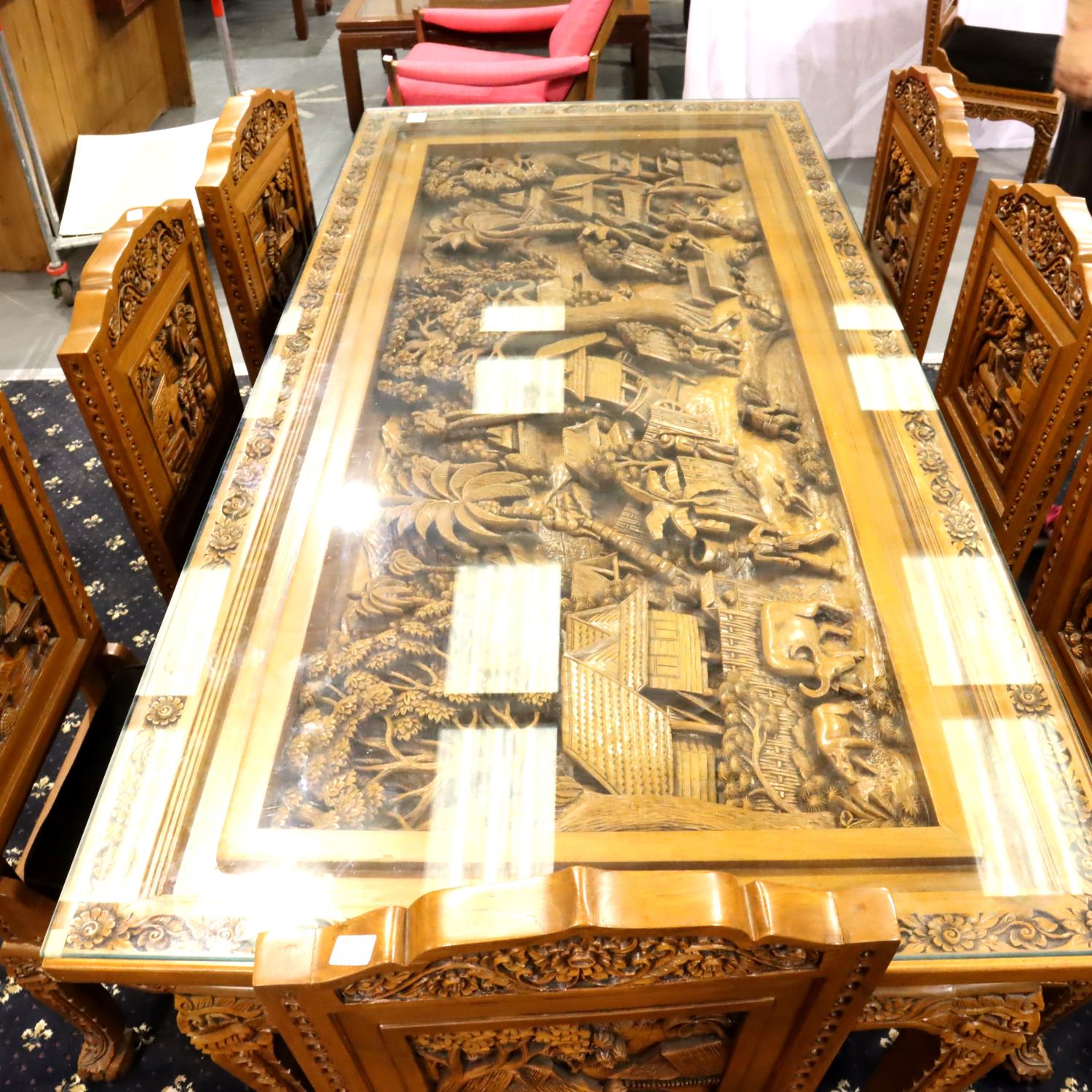 A deeply carved substantial Oriental hardwood dining table with plate glass top displaying figures - Image 14 of 14