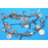 Unusual hallmarked silver charm necklace, (30 charms) chain L: 56 cm, combined 109g. Few charms
