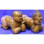 A pair of contemporary carved hardwood stools in the form of kneeling Chinese children. Not