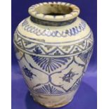 A Persian Faience baluster jar, 17th century, painted in blue with foliage and arabesque panels,
