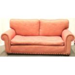 A contemporary two seat sofa with studs and upholstered in pink, L: 200 cm. Not available for in-