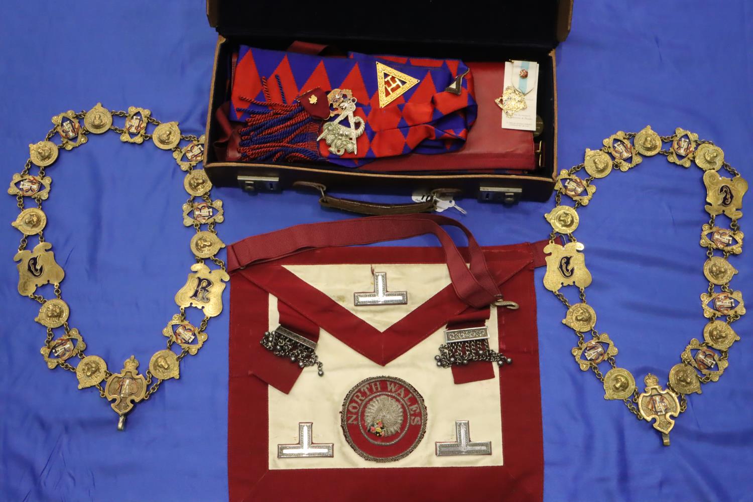 Brown leather regalia case containing Royal Arch apron, sash and jewels. P&P Group 2 (£18+VAT for