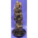 Substantial carved jade immortal figure raised on a carved circular base, figure has had repair,