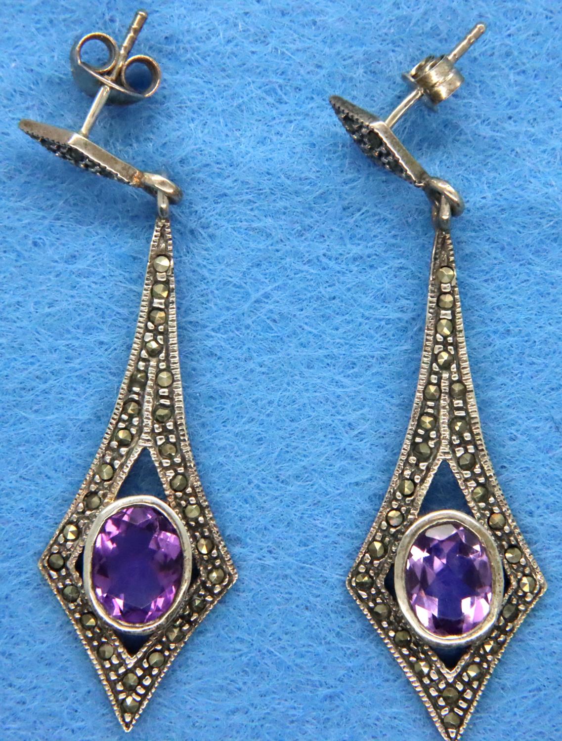 A pair of amethyst and marcasite silver earrings. P&P Group 1 (£14+VAT for the first lot and £1+