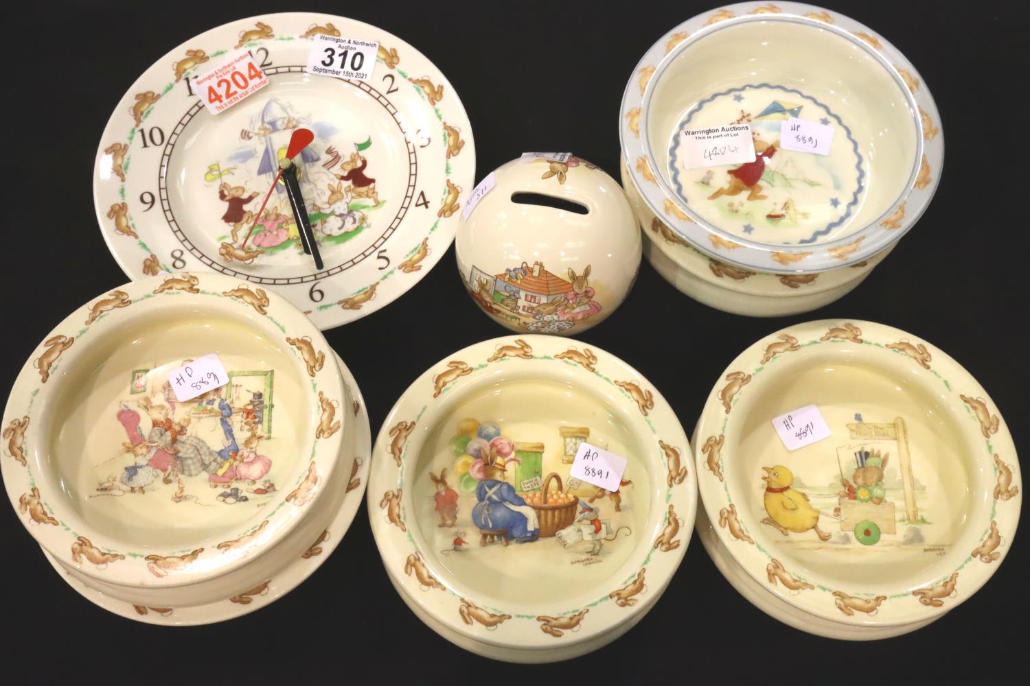 Royal Doulton Bunnykins; clock, six cereal bowls and a money box. No cracks, chips or visible