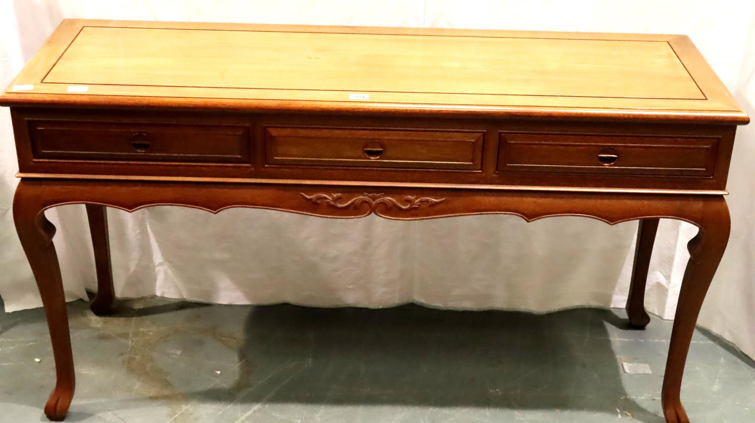 A contemporary three drawer console table in Oriental hardwood with carved hand pulls, 152 x 52 x 84