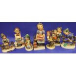 Seven Hummel figurines, each H: 16 cm. Loss of colour to some parts throughout all pieces, no