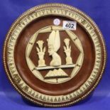 Framed circular bone plaque, D: 31 cm. P&P Group 3 (£25+VAT for the first lot and £5+VAT for