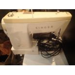 Cased Singer 533 electric sewing machine, with power cable, instructions and pedal. Not available