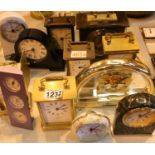 Twelve quartz, mantel, alarm and carriage clocks, all working at lotting. Not available for in-house