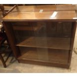 Two mahogany bookcases with glass sliding doors, one with double under cupboard, L: 100 cm. Not