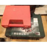 A cased Bosch PSR18 cordless drill with charger, two batteries and also a various sized drill hole