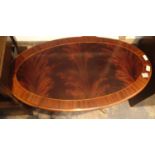 Vintage mahogany oval coffee table with flame top and brass paw feet, L: 100 cm. Not available for