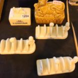 Three vintage Lurpak ceramic toast racks, a butter dish lid and a Sadler ceramic butter dish, with