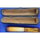 Antique block amber cigarette/cheroot holder in a fitted case, L: 90 mm. P&P Group 1 (£14+VAT for