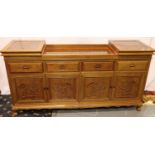 An Oriental hardwood sideboard buffet, the cupboard doors with carved facias and folding top with