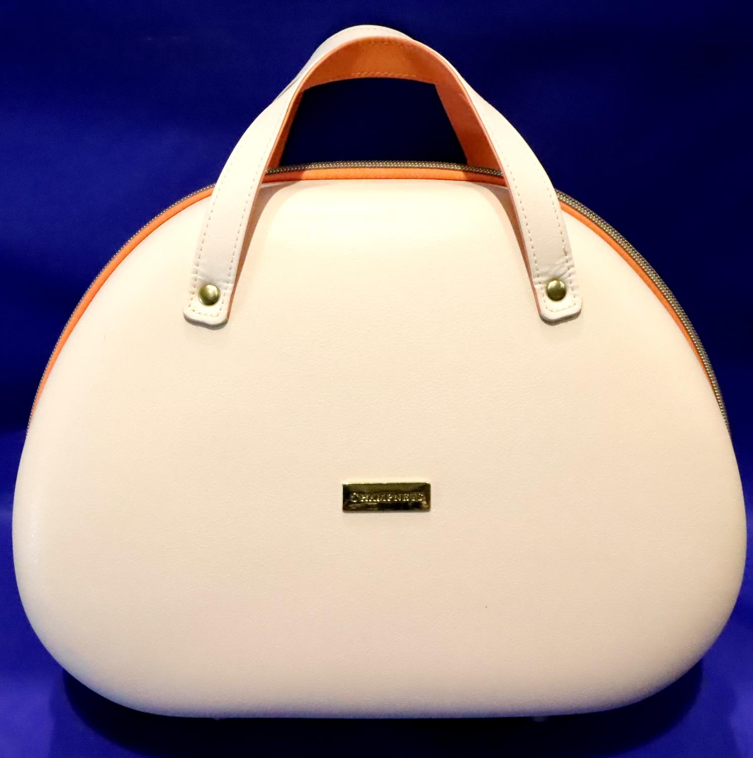 Cream hard cased Champneys travel handbag, L: 35 cm. P&P Group 2 (£18+VAT for the first lot and £3+