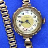 Ladies 9ct yellow gold Art Deco wristwatch with iridescent chapter ring and plated adjustable strap.