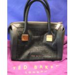 Black leather handbag by Ted Baker, with dust cover, L: 29 cm. P&P Group 2 (£18+VAT for the first