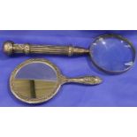 Large metal handled magnifying glass and a dressing table mirror. P&P Group 3 (£25+VAT for the first