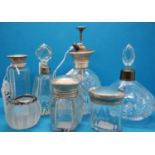 Cut glass silver topped atomiser, two scent bottles with silver collars, two glass jars with