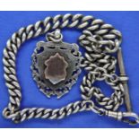 A hallmarked silver graduated single Albert watch chain with fob, lobster clip and T-bar, L: 32
