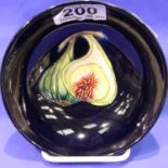 Moorcroft footed bowl, Blue ground in the Queens choice pattern, Impressed and painted marks to