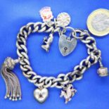 Silver charm bracelet with seven charms. P&P Group 1 (£14+VAT for the first lot and £1+VAT for