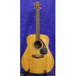 Yamaha F310 six string acoustic guitar with stand, in very good condition. Not available for in-