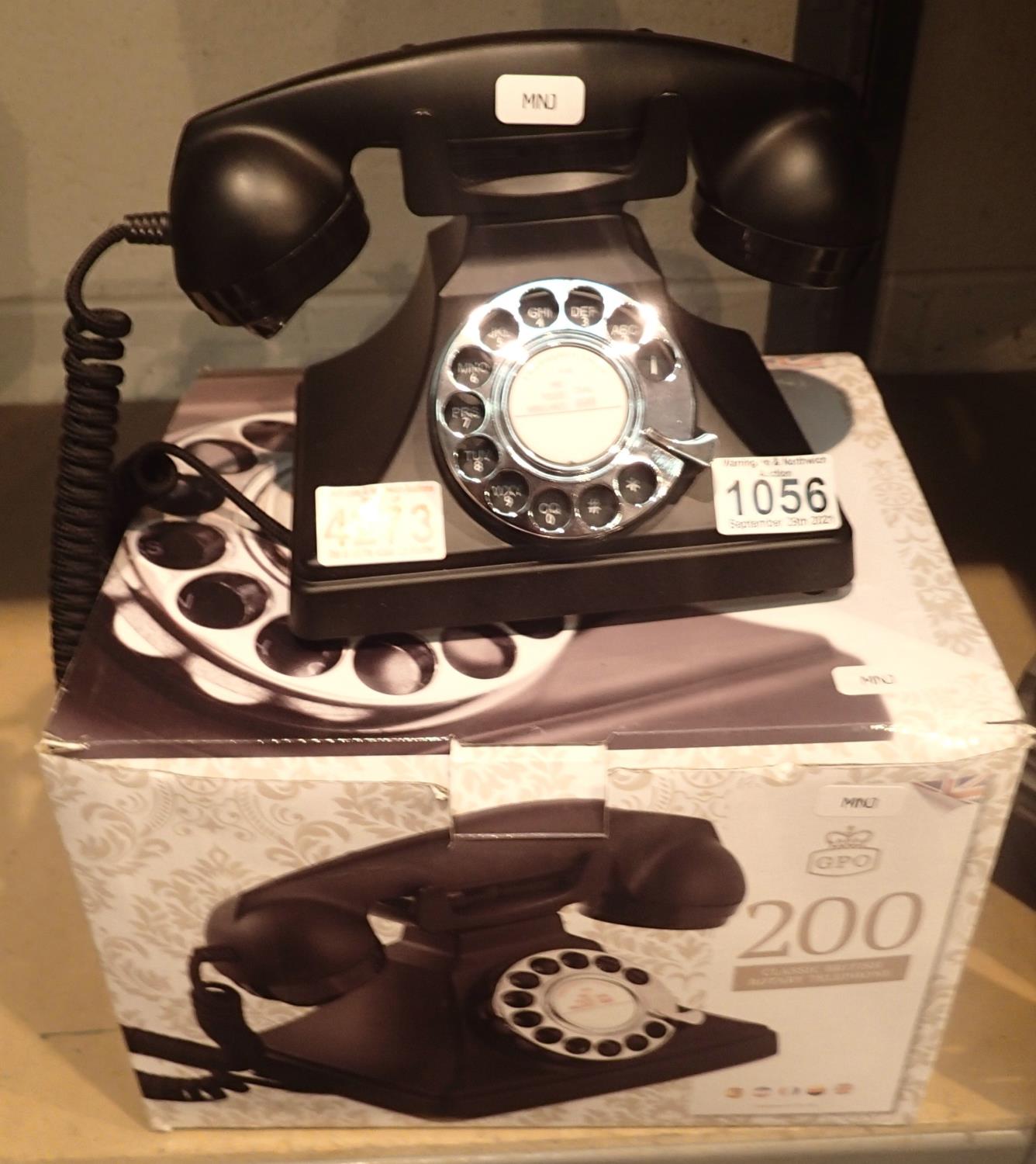 The GPO 200 rotary telephone has a metal base and handset; traditional cloth handset curly cord & is