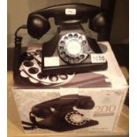 The GPO 200 rotary telephone has a metal base and handset; traditional cloth handset curly cord & is