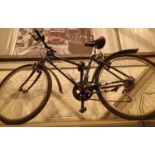 Womans Raleigh 10 geared road bike with Shimano shifter, mud guard and kick stand. Not available for