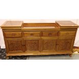 An Oriental hardwood sideboard buffet, the cupboard doors with carved facias and folding top with