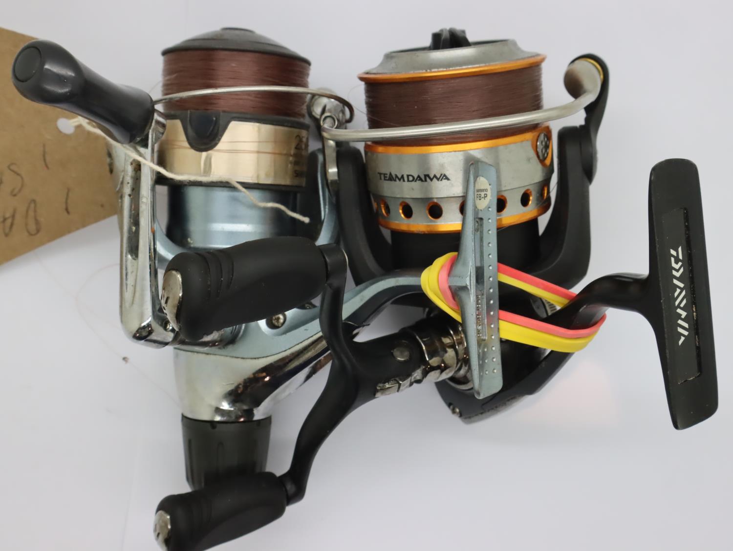 Daiwa fixed spool reel and a Shimano 2500 example. P&P Group 2 (£18+VAT for the first lot and £3+VAT